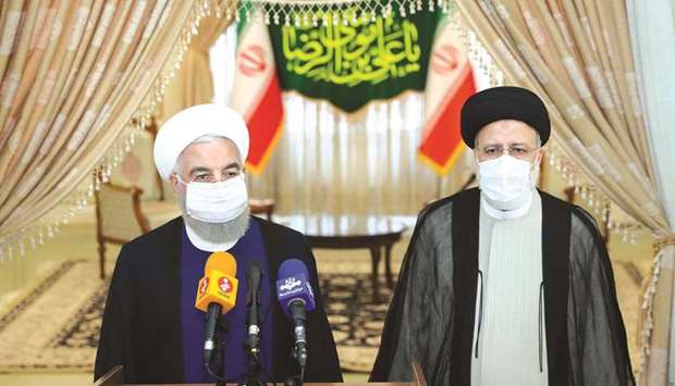 Iranu2019s outgoing President Hassan Rouhani and Iranu2019s President-elect Ebrahim Raisi speak to the media after their meeting in Tehran, yesterday.