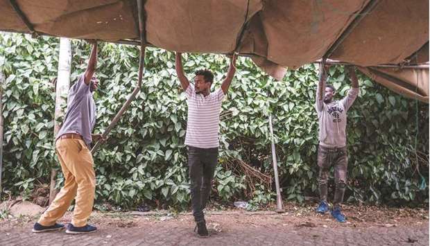 Workers set up a tent, that will be used as a polling station in the upcoming elections tomorrow, in the city of Bahir Dar, yesterday.