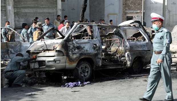 Afghan security forces inspect the wreckage of a passenger van after a blast in Kabul, Afghanistan on June 12.REUTERS