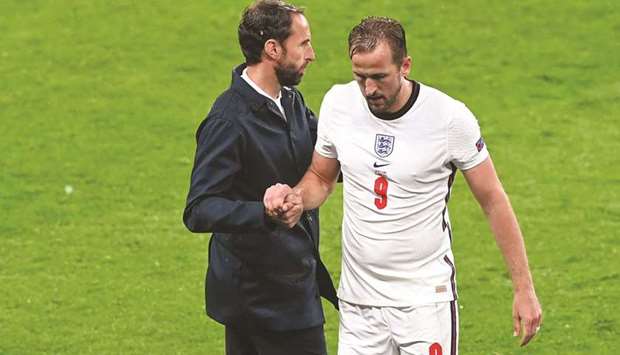 Englandu2019s Harry Kane (right) shakes hands with manager Gareth Southgate after being substituted during the UEFA Euro Group D match against Scotland at Wembley Stadium in London, England, on Friday. (Reuters)