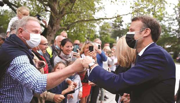 French President Emmanuel Macron greets voters at a polling station during the first round of regional and departmental elections in Le Touquet-Paris-Plage yesterday. (Reuters)