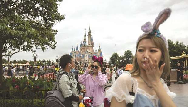 Visitors attend celebrations for the 5th anniversary of the Shanghai Disneyland theme park at the resort in Shanghai on June 16. The Asia-Pacific region recovered from the pandemic recession at the end of last year thanks to the resilience of Chinau2019s economy.