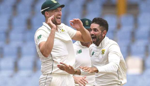  Keshav Maharaj (R) and Wiaan Mulder (L) of South Africa celebrate the dismissal of Jason Holder of West Indies in Gros Islet on Sunday.