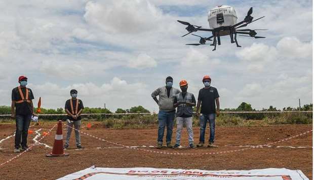 Technicians fly a drone belonging to the Throttle Aerospace Systems (TAS) which flies Beyond Visual Line of Sight (BVLOS) to deliver life saving medical supplies during a flight testing at Gauribidanur, about 80 km from Bangalore yesterday. AFP