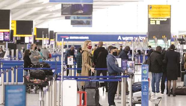 Passengers wait at check-in desks in the departures hall in Terminal 5 at London Heathrow Airport. Processing times at airports have ballooned, post-Covid-19 as authorities need to verify health credentials of travellers, which has already led to confusion in many airports around the world.