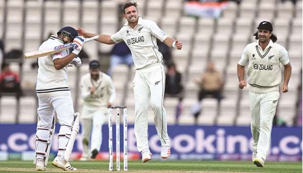 New Zealandu2019s Tim Southee (C) celebrates dismissing Indiau2019s Rohit Sharma (L) for 30 runs on the fifth day of the ICC World Test Championship Final at the Ageas Bowl in Southampton on Tuesday.