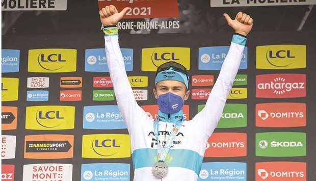 Team Astanau2019s Alexey Lutsenko of Kazakhstan celebrates on the podium after winning the fourth stage of the 73rd edition of the Criterium du Dauphine cycling race, a 16km time trial between Firmigny and Roche-la-Moliere, yesterday. (AFP)