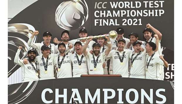 New Zealandu2019s captain Kane Williamson lifts the winneru2019s Mace as his teammates celebrate victory on the final day of the ICC World Test Championship Final against India at the Ageas Bowl in Southampton, southwest England, yesterday. (AFP)