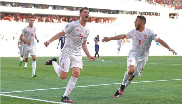 Spainu2019s Aymeric Laporte celebrates with teammate Koke (right) after scoring a goal during the UEFA Euro Group E match against Slovakia at La Cartuja Stadium in Seville, Spain, yesterday. (Reuters)