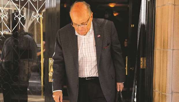 Former New York City mayor Giuliani exits his apartment building after his law licence was suspended.