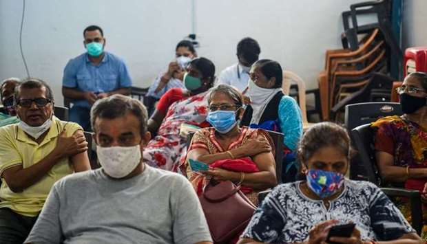 People wait in an observation area after getting inoculated with a dose of the Covishield AstraZeneca-Oxford's Covid-19 coronavirus vaccine at the Rajawadi Hospital in Mumbai on June 22. AFP