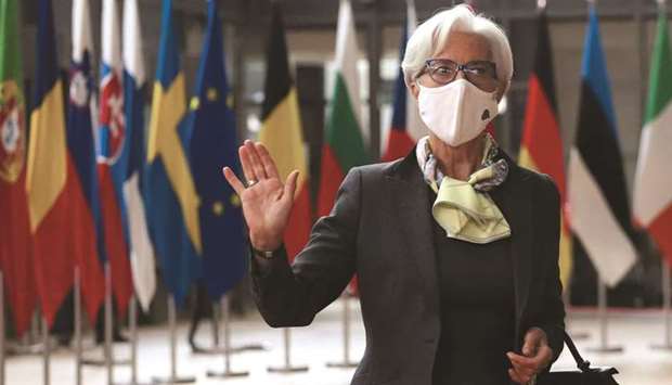 ECB president Christine Lagarde gestures as she arrives at an EU summit in Brussels yesterday. At the summit, Lagarde said continued support is needed to avoid the pandemic leaving large scars on the economy, according to an official familiar with her remarks.