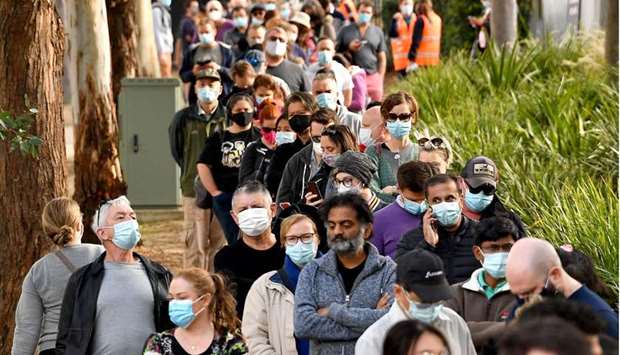 Sydneysiders queue outside a vaccination centre in Sydney as residents were largely banned from leaving the city to stop a growing outbreak of the highly contagious Delta Covid-19 variant spreading to other regions.