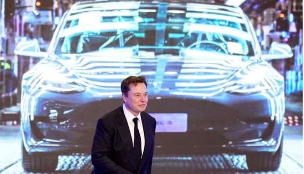 Tesla Inc CEO Elon Musk walks next to a screen showing an image of Tesla Model 3 car during an opening ceremony for Tesla China-made Model Y program in Shanghai, China on January 7, 2020. REUTERS