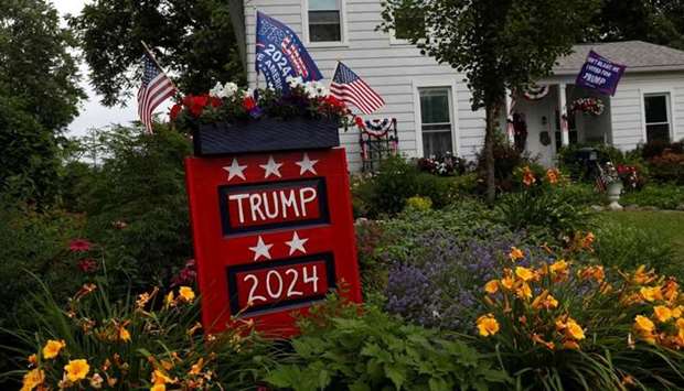 Signs are seen for former US President Donald Trump, before his first post-presidency campaign rally at the Lorain County Fairgrounds, outside a home near Wellington, Ohio. REUTERS