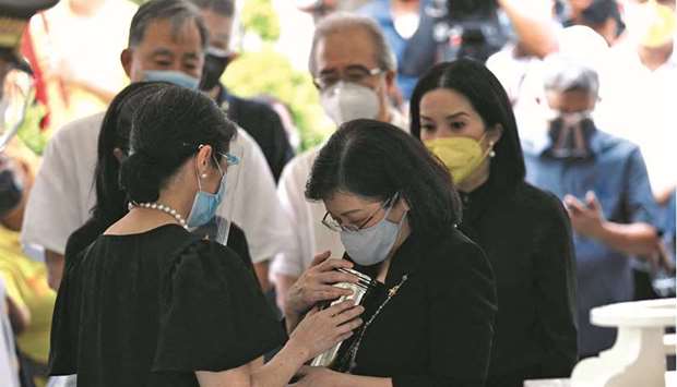 This handout photo taken yesterday and received from the Office of the Vice-President shows Pinky Aquino-Abellada holding the urn of her brother, the late president Benigno Aquino, during the ceremony at a memorial park in Manila. With her are sisters Ballsy Aquino-Cruz (left), Viel Aquino-Dee (partly hidden) and Kris Aquino (right).