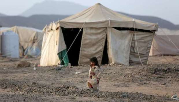 A girl walks past a tent at a camp for internally displaced people (IDPs) in Marib, Yemen April 5. REUTERS