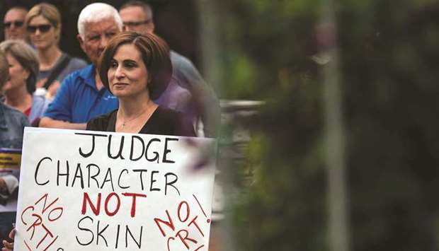 In this file photo taken earlier this month, a woman holds up a sign during a rally against u201ccritical race theoryu201d (CRT) being taught in schools at the Loudoun County Government centre in Leesburg, Virginia. (AFP)
