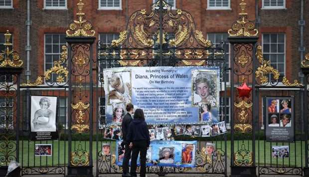 People look at tributes for Britain's Princess Diana, outside Kensington Palace in London, Britain yesterday. REUTERS