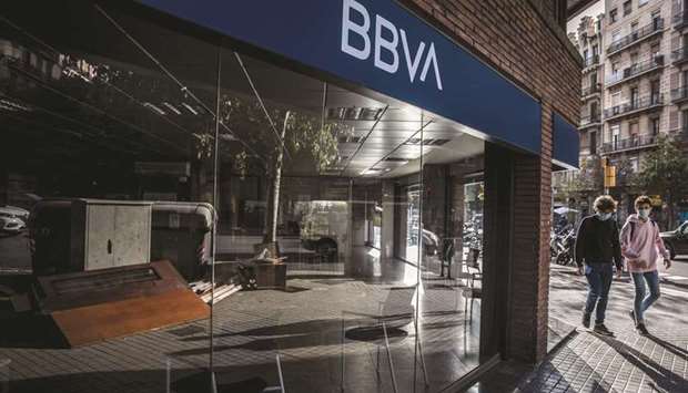 Pedestrians pass a branch of BBVA in Barcelona. Spanish banksu2019 staff have recently been holding protests against plans by five lenders to cut around 18,000 jobs.