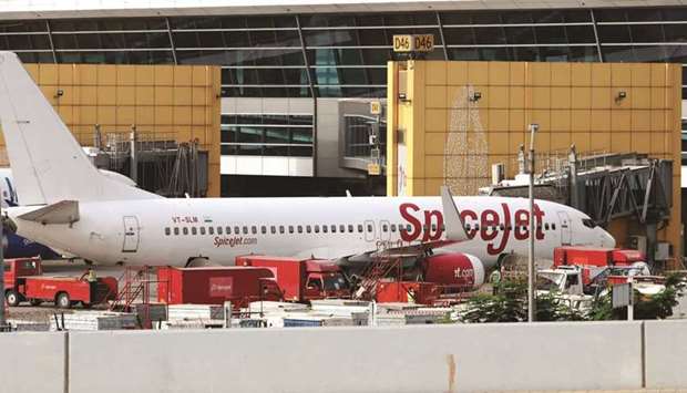 A SpiceJet aircraft stands at Terminal 3 of Indira Gandhi International Airport in New Delhi. SpiceJet booked other income of Rs10.9bn ($150mn) in the seven quarters through December. That was the amount it expected to get in compensation from Boeing for not being able to fly its 13 MAX aircraft, helping the company to trim its losses during deeply challenging times.