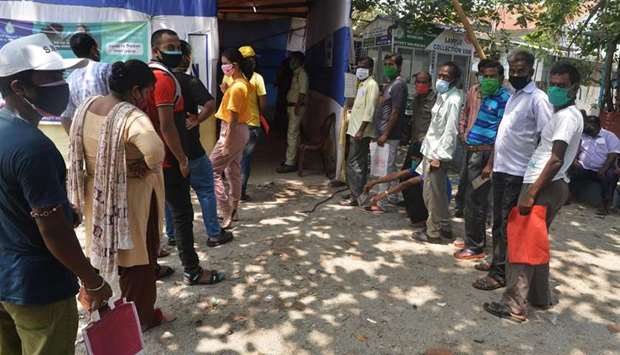 People wait to receive a dose of the Covishield vaccine against the Covid-19 coronavirus at a primary health centre in Siliguri 
