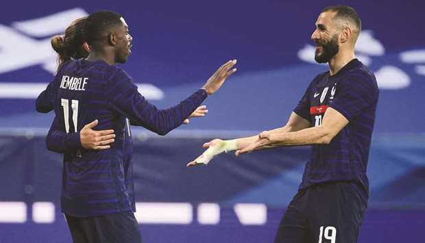 Franceu2019s Ousmane Dembele (left) celebrates with Karim Benzema after scoring during the friendly match against Wales at the Allianz Riviera Stadium in Nice, southern France. (AFP)