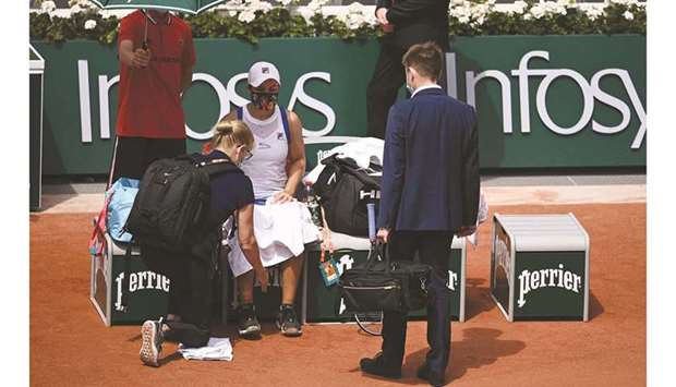 Australiau2019s Ashleigh Barty is treated by medical staff during her French Open second round match against Polandu2019s Magda Linette (not pictured) at Roland Garros in Paris, France, yesterday. (AFP)