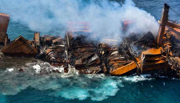 Smoke rises from a fire onboard the MV X-Press Pearl vessel as it sinks while being towed into deep 