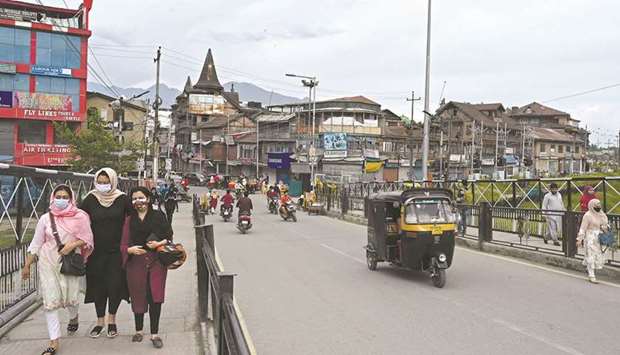 Shoppers walk through a market area following a partial relaxation in the lockdown imposed to curb the spread of the Covid-19 coronavirus in Srinagar yesterday.