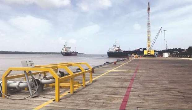 SPOTLIGHT: Vessels carrying supplies for an offshore oil platform operated by Exxon Mobil at the Guyana Shore Base Inc wharf on the Demerara River, south of Georgetown, Guyana in January last year. (File photo)