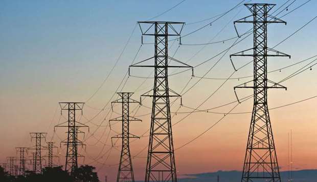 Power transmission lines are suspended from electricity pylons in Kearny, New Jersey. Blackouts triggered by extreme weather in Texas and California over the past year have reignited a debate over whether other regions should institute capacity systems similar to the one used by PJM Interconnection.