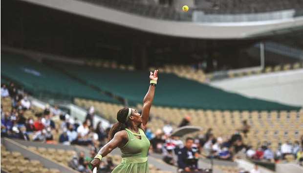 Serena Williams of the US serves the ball to compatriot Danielle Collins (not pictured) during their French Open third round match at Roland Garros in Paris, France, yesterday. (AFP)