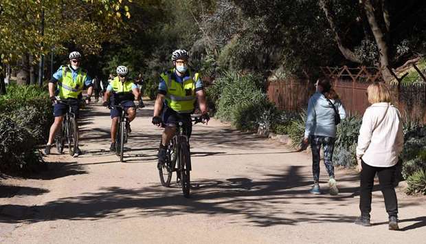 Police on bicycles patrol in Melbourne with the coronavirus lockdown of Australia's second-biggest city to be extended by another seven days