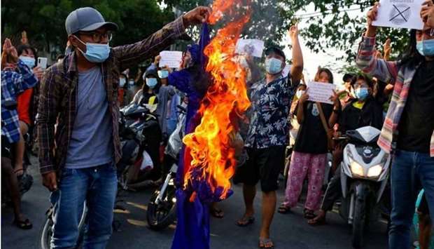 Protesters against Myanmar's junta burn the flag of the Association of Southeast Asian Nations (ASEAN), in Mandalay, Myanmar