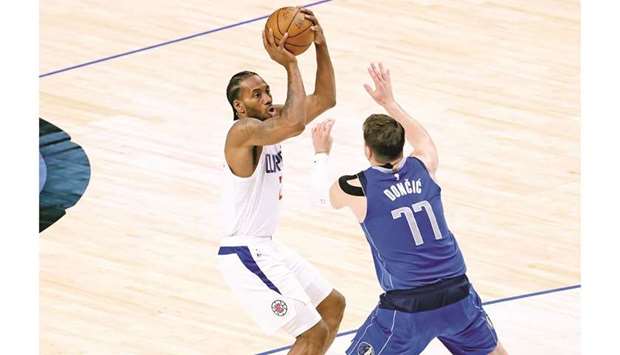 LA Clippers forward Kawhi Leonard shoots over Dallas Mavericks guard Luka Doncic during the fourth quarter in game six of the first round of the 2021 NBA Playoffs at American Airlines Center. (USA TODAY Sports)