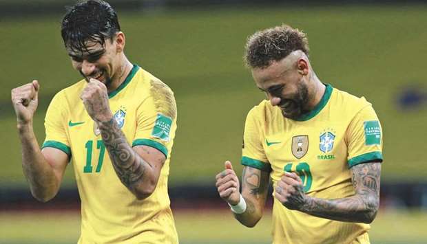 Brazilu2019s Neymar (right) celebrates with teammate Lucas Paqueta after scoring a penalty against Ecuador during their South American qualification match for the FIFA World Cup Qatar 2022 in Porto Alegre, Brazil, on Friday night. (AFP)
