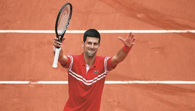 Serbiau2019s Novak Djokovic celebrates after winning his French Open third round match against Lithuaniau2019s Ricardas Berankis (not pictured) at Roland Garros in Paris, France, yesterday. (Reuters)