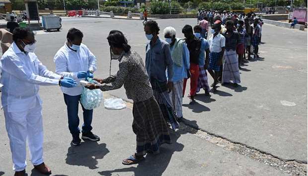 Volunteers of a non-governmental organisation organisation distribute food to people in need during a lockdown imposed in Tamil Nadu state to contain the Spread of Covid-19 coronavirus in Chennai