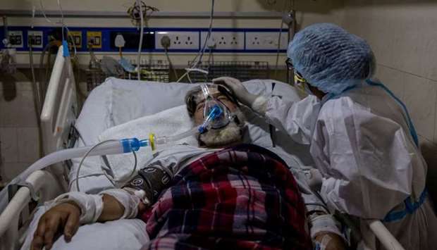 A medical worker tends to a patient suffering from the coronavirus disease, inside the ICU ward at Holy Family Hospital in New Delhi, India, April 29. REUTERS