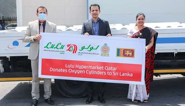 Sri Lanka's ambassador to Qatar, Mohamed Mafaz Mohideen, receives the oxygen cylinders consignment from Shaijan M O, regional director, LuLu Hypermarket Qatar.