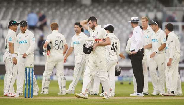 Englandu2019s Dom Sibley (centre) walks off the pitch at the end of the first Test against New Zealand at Lordu2019s Cricket Ground in London yesterday. (Reuters)