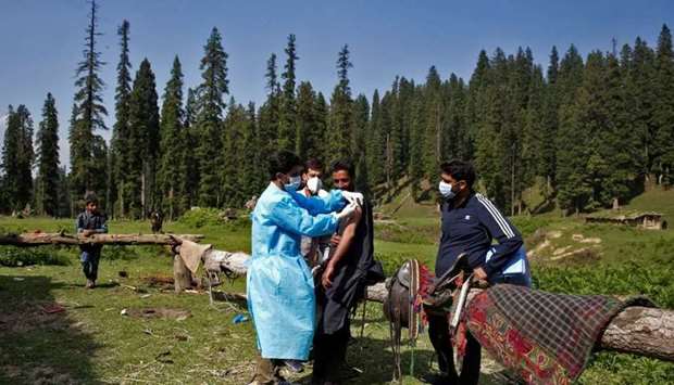A healthcare worker gives a dose of Covishield vaccine manufactured by Serum Institute of India, to a shepherd man during a vaccination drive at a forest area in south Kashmir's Pulwama district. REUTERS