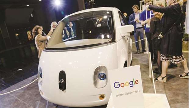 Attendees inspect a Google self-driving car at Viva Technology conference in Paris on June 30, 2016. The French competition authority determined that Google gave preferential treatment to its own ad inventory marketplace AdX and to the Doubleclick Ad Exchange, its real-time platform for letting clients choose and sell ads.