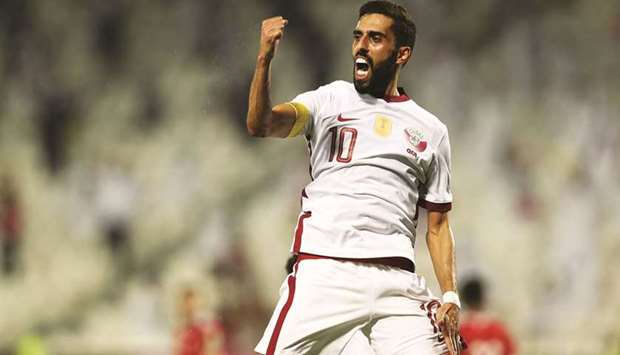 Qataru2019s Hassan al-Haydos celebrates after scoring off the penalty spot during the Asian Qualifiers for the FIFA World Cup Qatar 2022 and AFC Asian Cup China 2023 match against Oman on Monday.