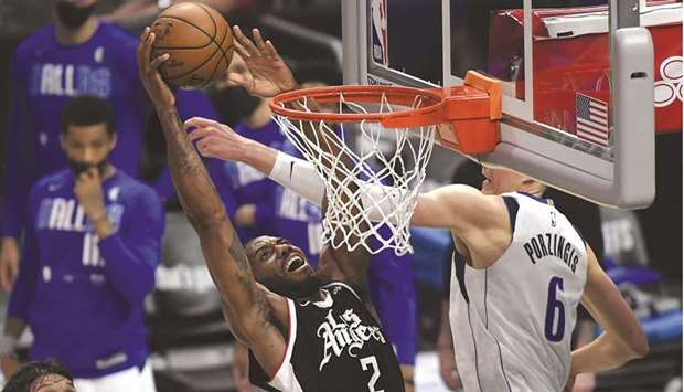 Kawhi Leonard of the Los Angeles Clippers dunks the ball against Kristaps Porzingis of the Dallas Mavericks during the second half of Game Seven of the Western Conference first round series at the Staples Center in Los Angeles. (Getty Images/AFP)
