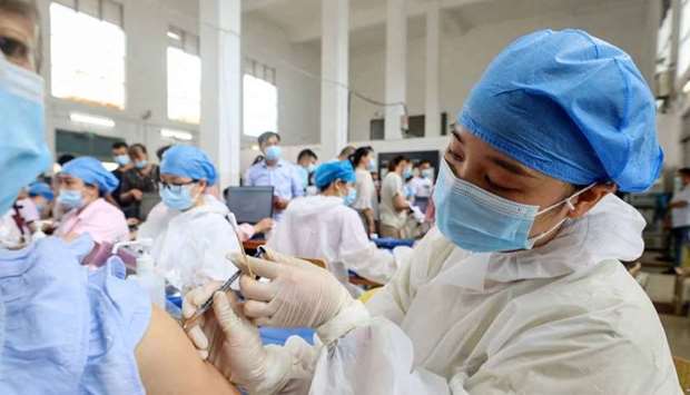 A health worker administering the Sinovac Covid-19 coronavirus vaccine to a resident in Rongan, in China's southern Guangxi region on June 3, 2021