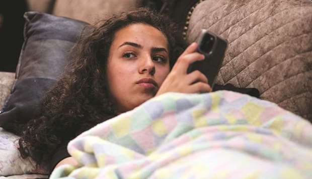 Jana Kiswani, 16, looks on as she rests at home after she was injured when a police officer shot her in the back as she was entering her home in the Sheikh Jarrah neighbourhood of East Jerusalem.