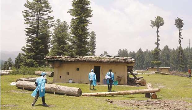 Healthcare workers head to a hut to inoculate shepherds during a Covid vaccination drive at a forest area in south Kashmiru2019s Pulwama district, yesterday.