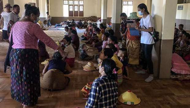 People displaced from recent fighting between government troops and ethnic rebels in their area, wait for food distribution from a volunteer group while taking refuge at a monastery in Namlan town, in Myanmar's eastern Shan state.